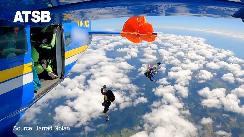 Video shows skydiver dangling from plane after parachute gets caught