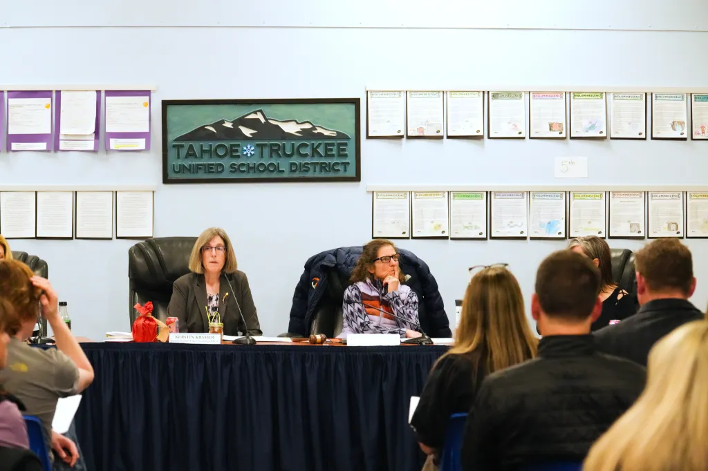Two women sit at a table before an audience at a Tahoe Truckee Unified School District meeting.