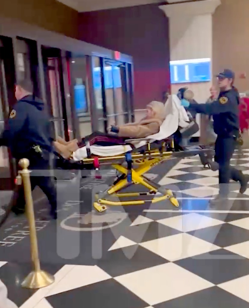 Tara Reid on a stretcher being moved by paramedics.