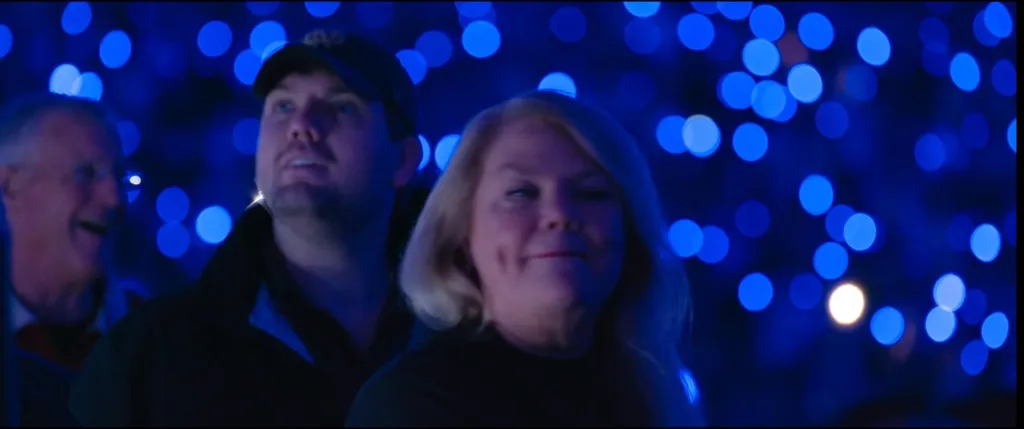 People in the audience watching Taylor Swift's Eras Tour concert.