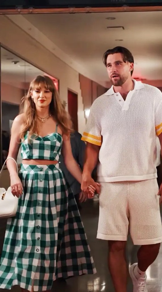 Taylor Swift and Travis Kelce walking hand-in-hand.