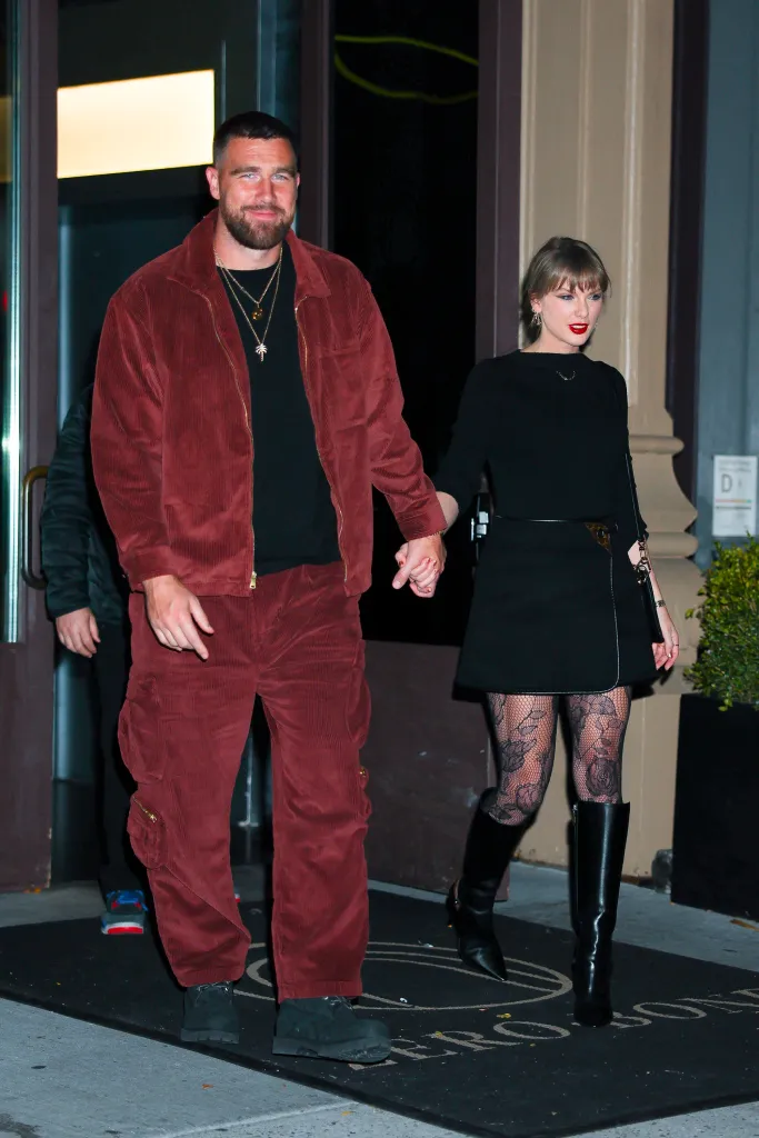 Taylor Swift and Travis Kelce holding hands while walking in New York City.