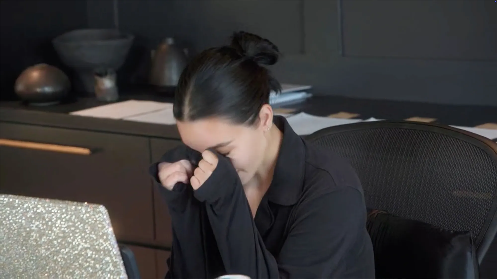 Kim Kardashian crying at a desk.