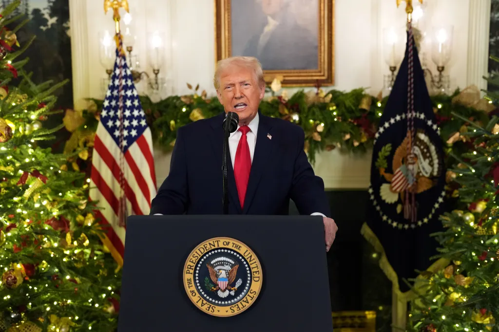 Donald Trump giving a prime-time address from the White House, standing behind a podium with the Presidential Seal.