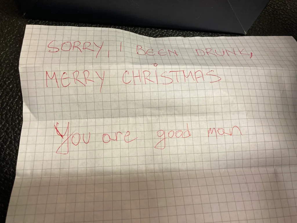 A handwritten note in red ink on graph paper that reads, 