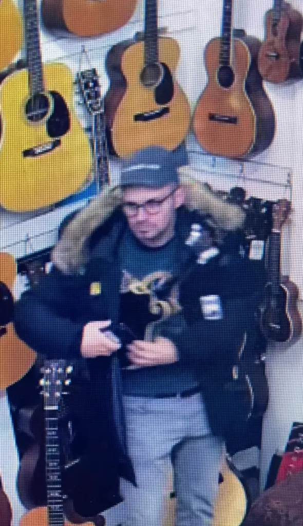 Surveillance footage of the thief who stole two mandolins from a music store.