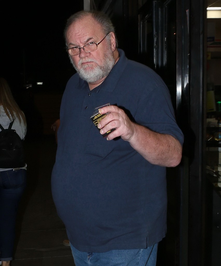 Thomas Markle holding a pack of cigarettes.