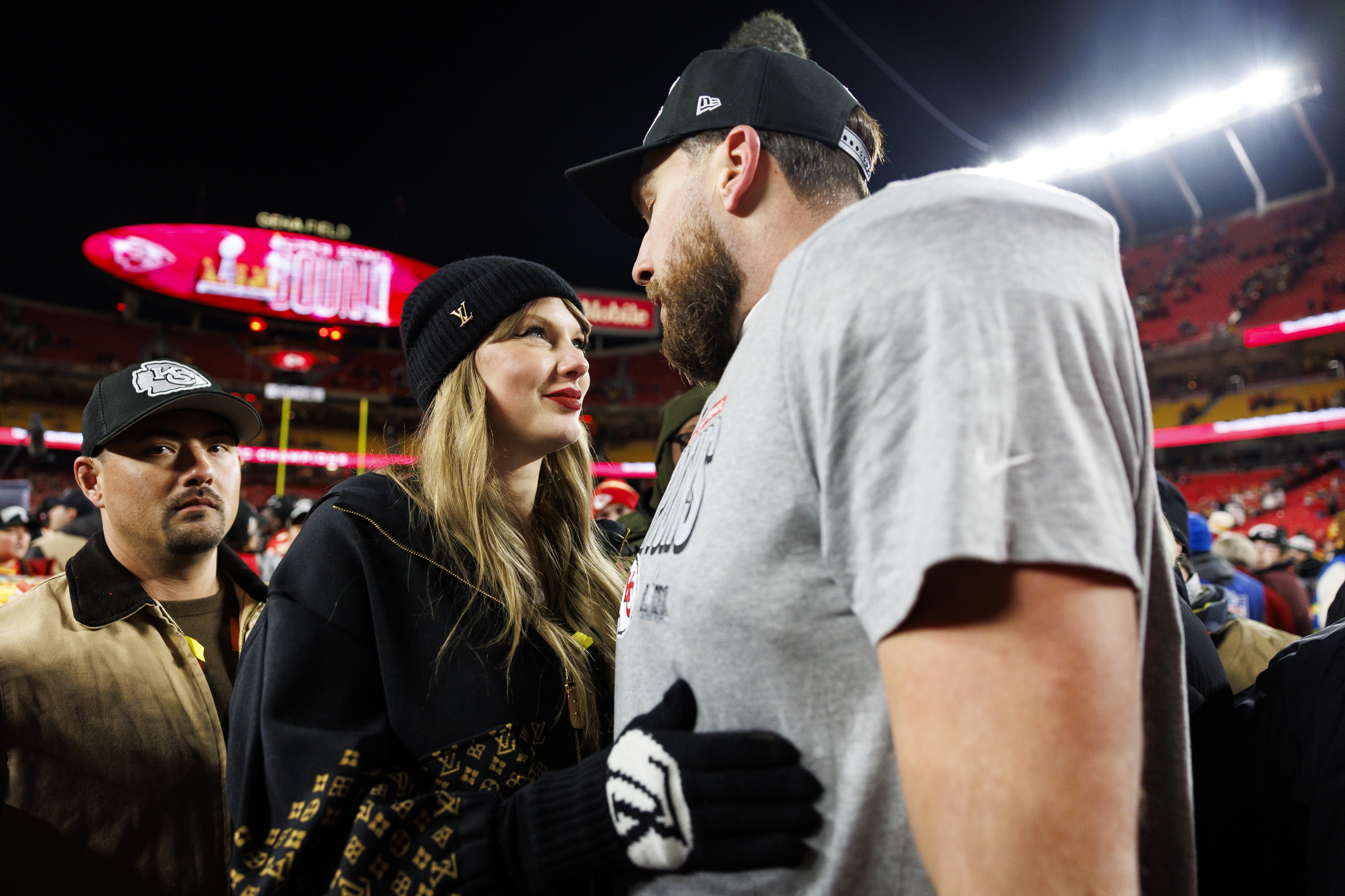 Travis Kelce and Taylor Swift celebrating at GEHA Field.