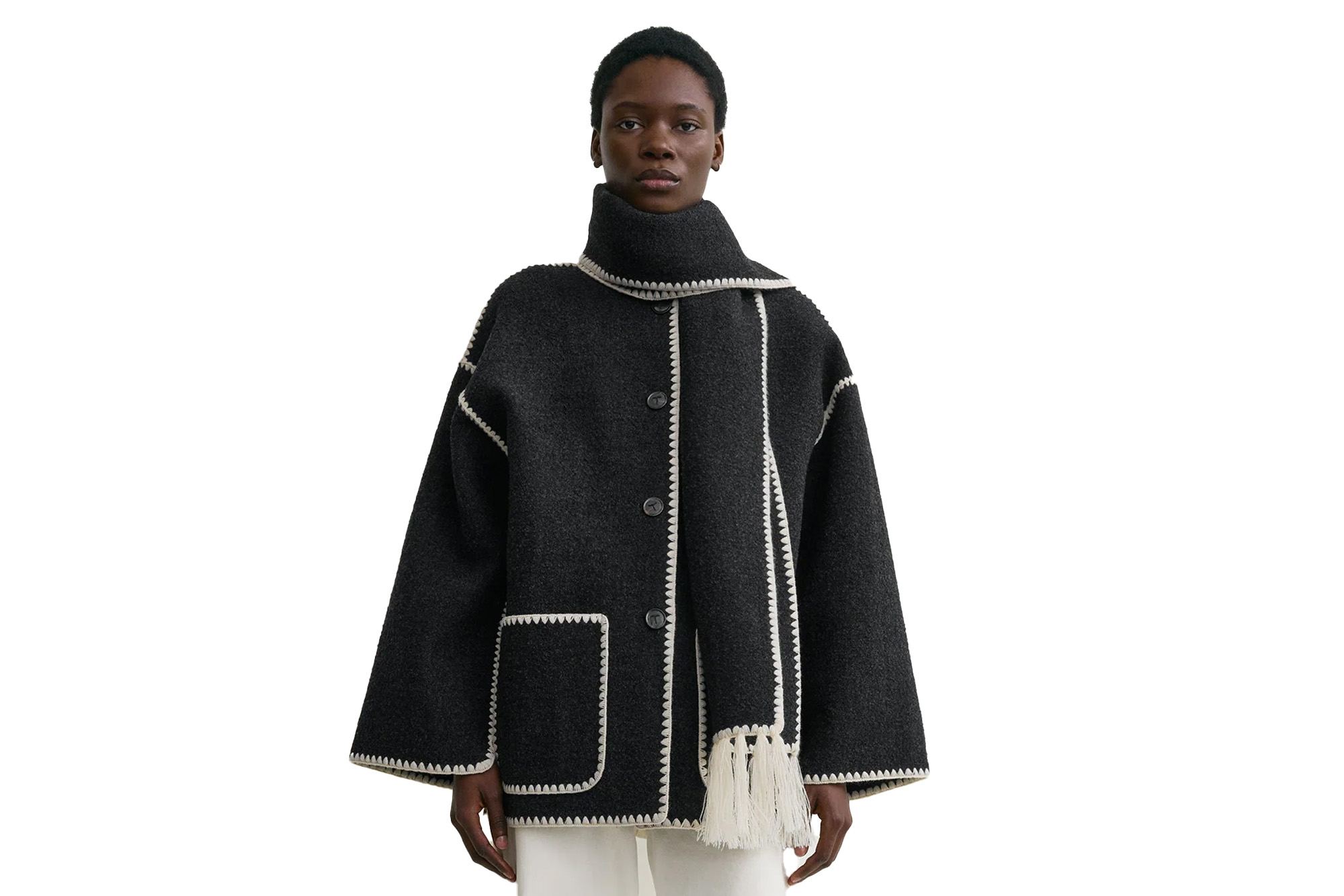 A person modeling a charcoal coat with a matching scarf and white trim detail.