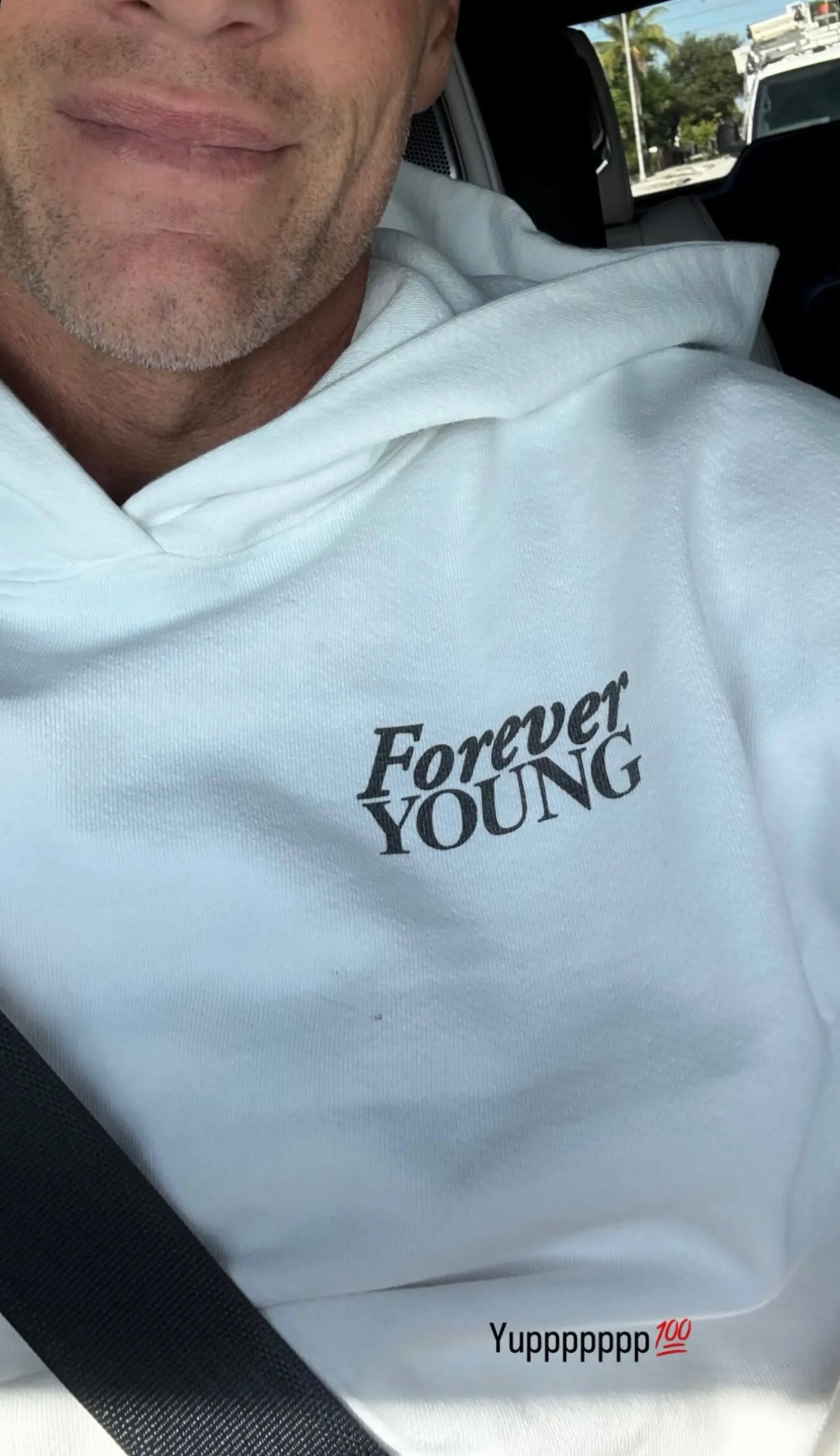 Tom Brady wearing a white hoodie with