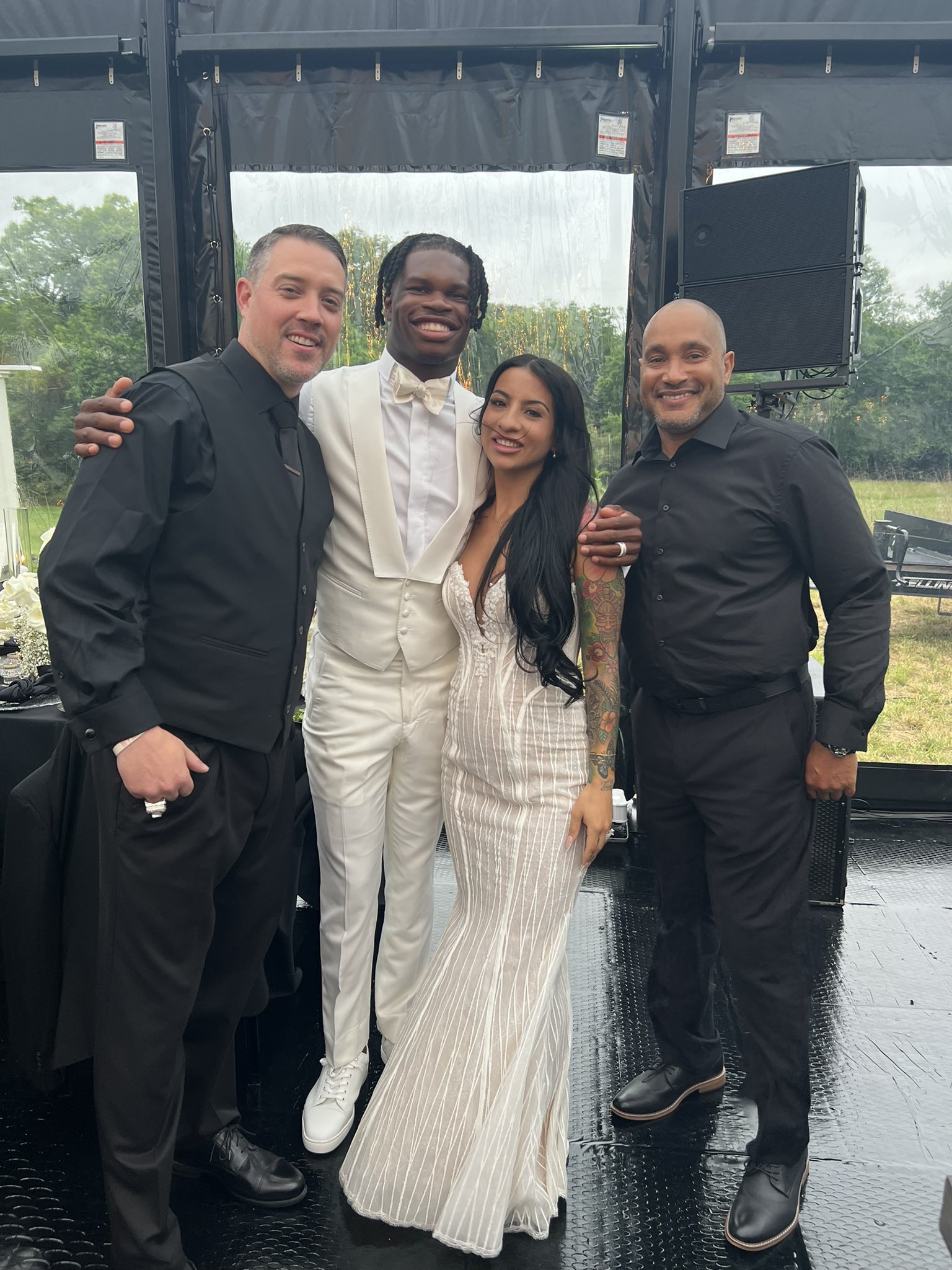 Travis Hunter and Leanna Lenee with friends on their wedding day