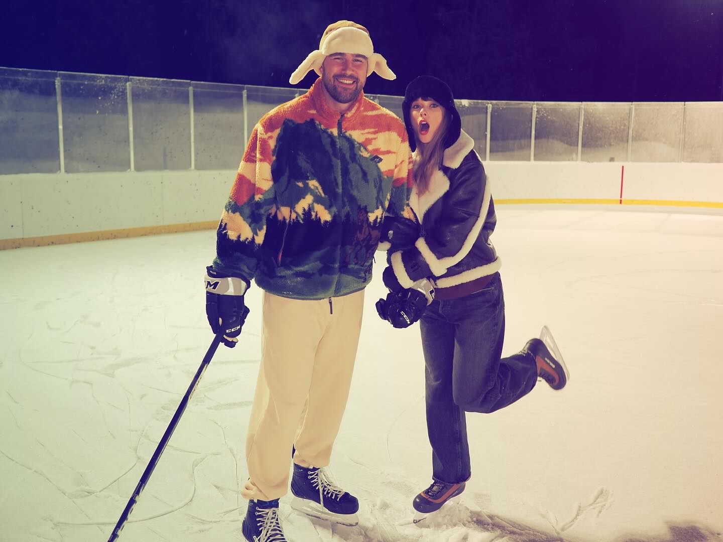 Travis Kelce and Taylor Swift on an ice rink.