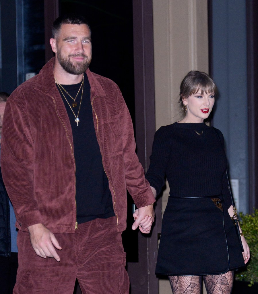 Travis Kelce and Taylor Swift holding hands.