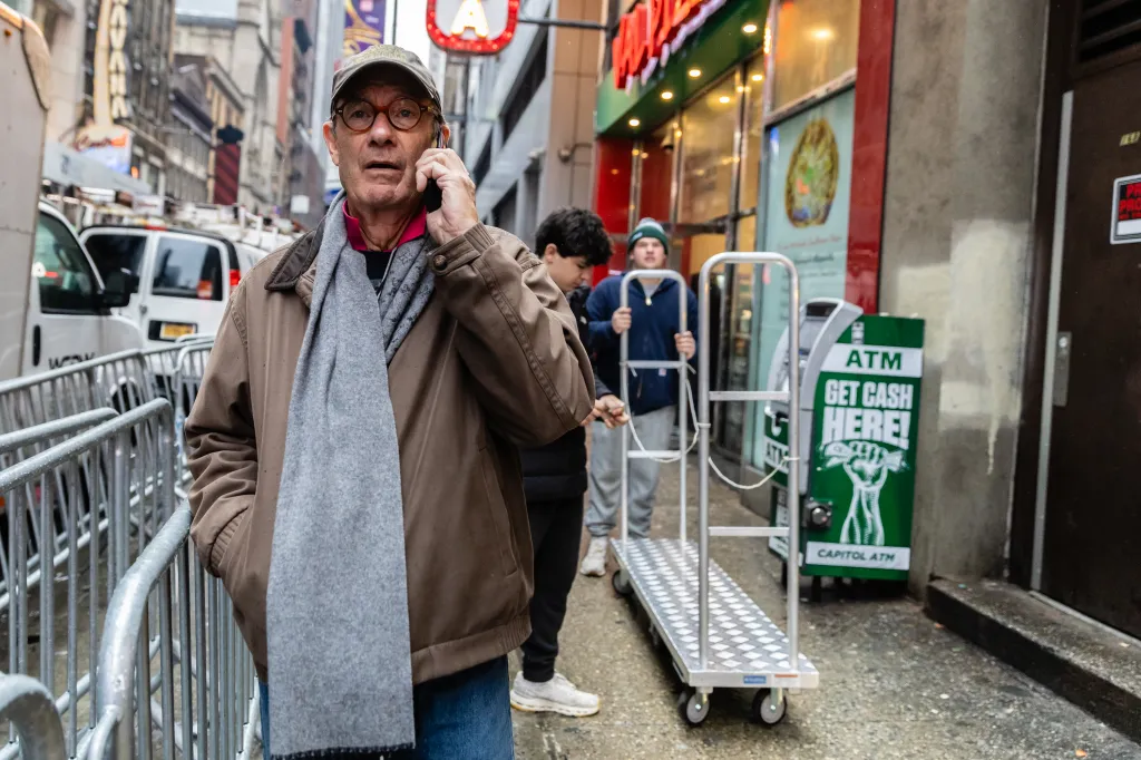 Treb Heining on the phone with a team member while delivering confetti in Times Square.