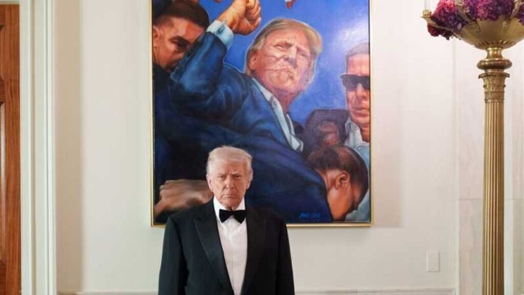 Trump poses with a photo from his assassination attempt after a wave of deadly shootings