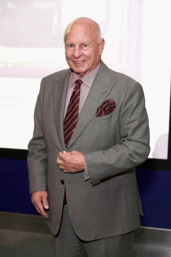 Thomas Girardi in a grey suit, maroon shirt, and striped maroon tie and pocket square.