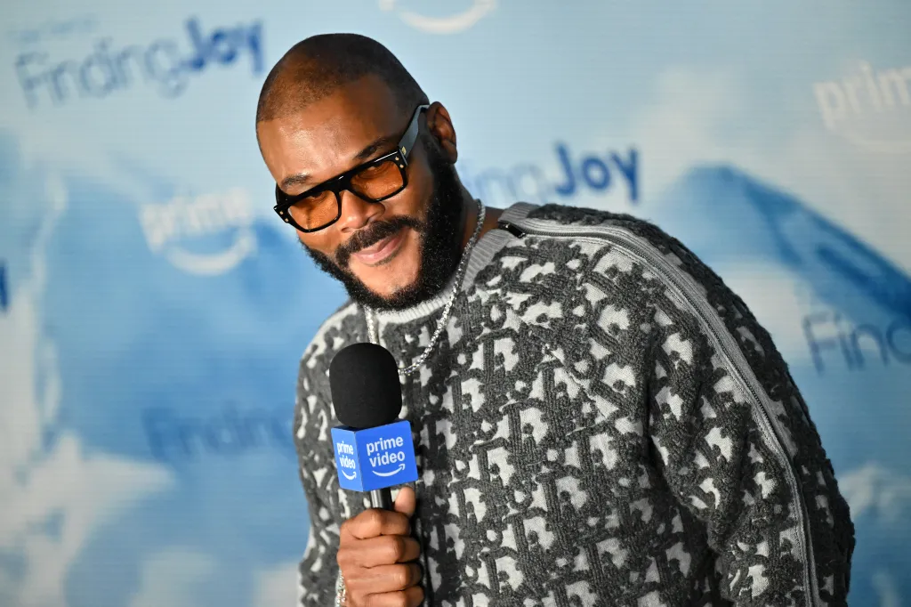 Tyler Perry speaks into a Prime Video microphone during a screening event.