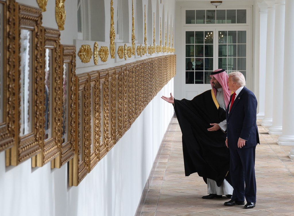 President Trump and Crown Prince Mohammed bin Salman walk along the colonnade at the White House.