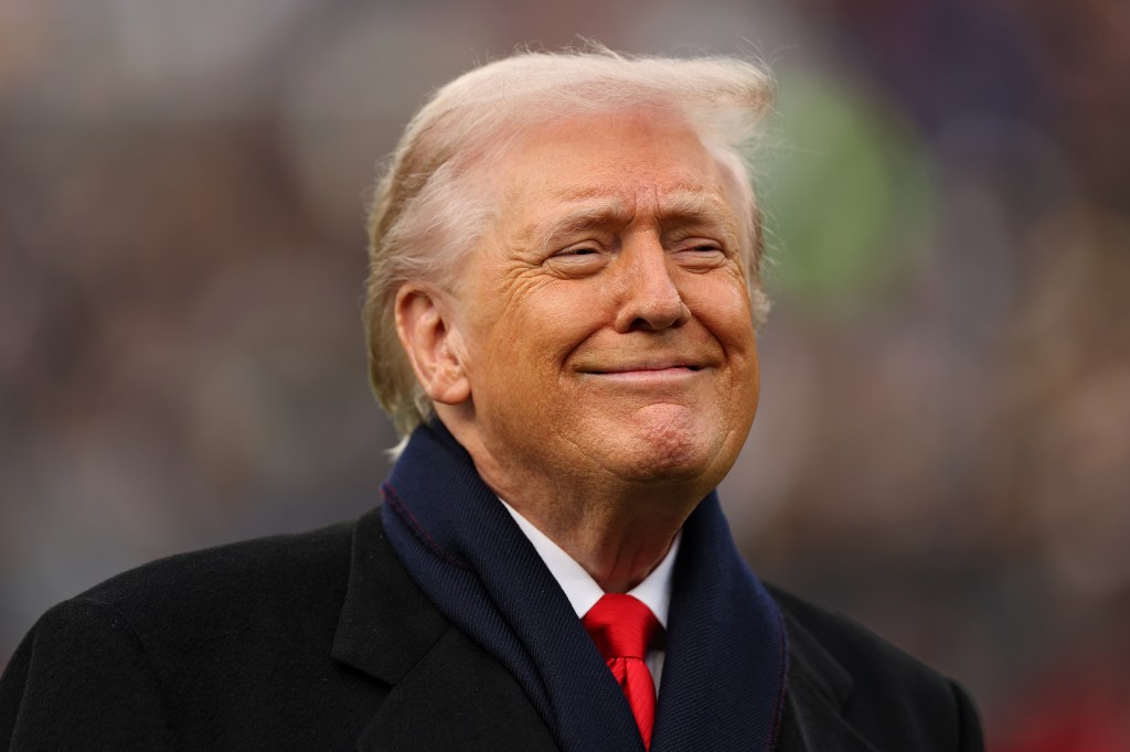 President Donald Trump smiling on a football field before the 126th Army-Navy Game.