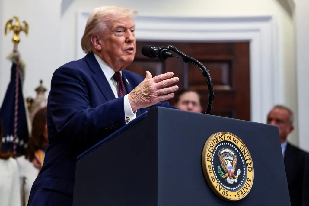 U.S. President Donald Trump makes an announcement at a podium bearing the seal of the President of the United States.