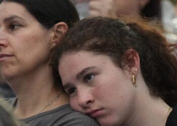 As thousands gather at Bondi Beach to mourn victims, Australian leader is booed