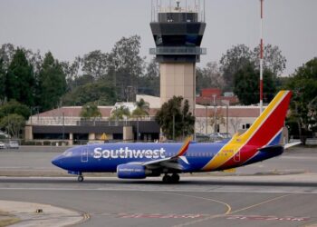 Car drives onto active taxiway at O.C. airport; driver is hospitalized, official says