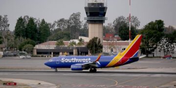 Car drives onto active taxiway at O.C. airport; driver is hospitalized, official says