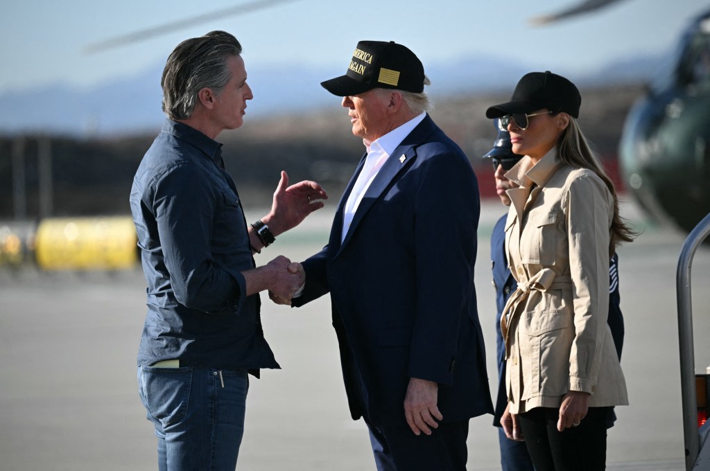President Donald Trump followed by First Lady Melania Trump, shakes hands with California Governor Gavin Newsom upon arrival at Los Angeles International Airport in Los Angeles, California, on January 24, 2025.