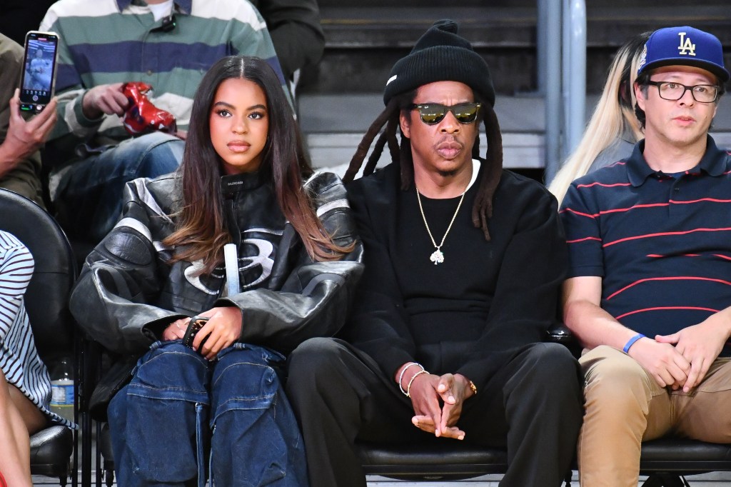 Jay-Z and Blue Ivy Carter attend a basketball game.
