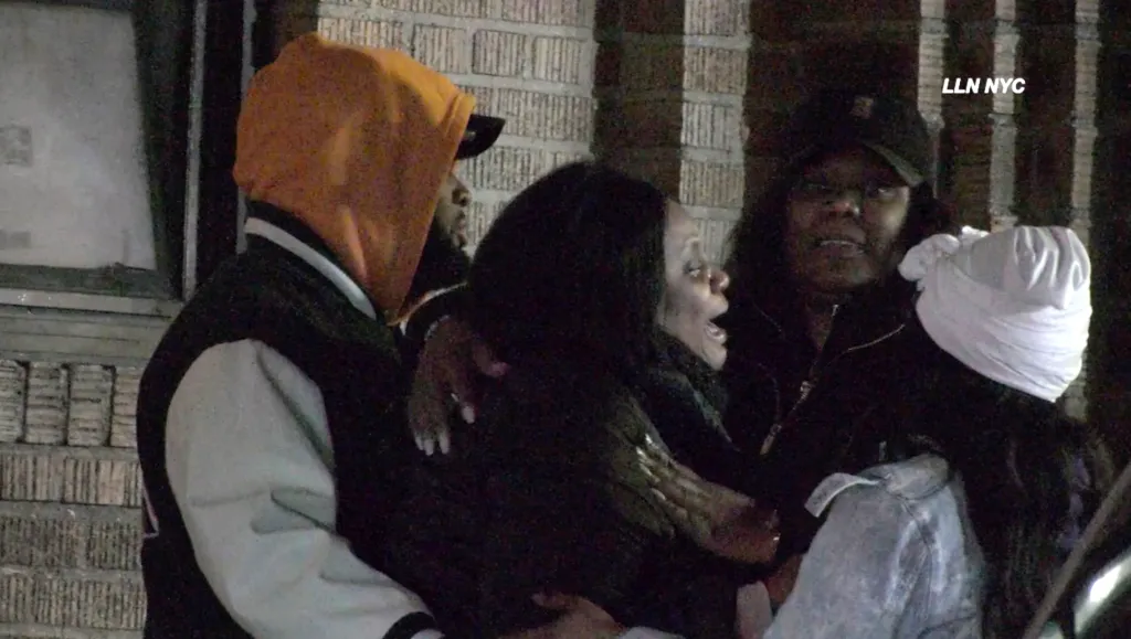 Shernett Dunbar, the mother of deceased 29-year-old Chez Fray, is consoled by others.