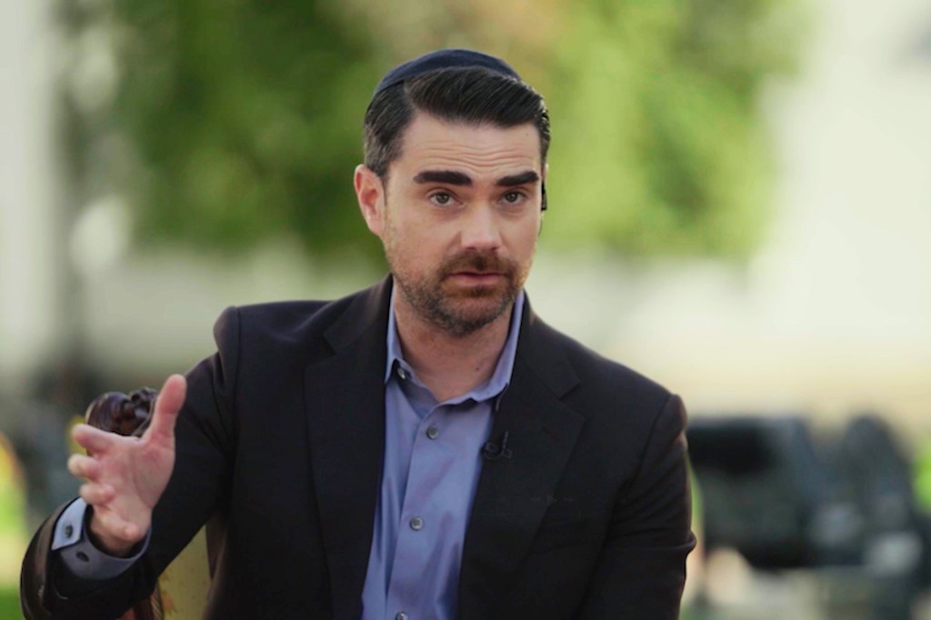 Ben Shapiro in a dark suit jacket, blue shirt, and yarmulke, speaking during his interview with Ukrainian President Volodymyr Zelenskyy.