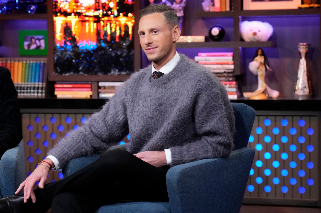 Fraser Olender sitting in a blue chair.