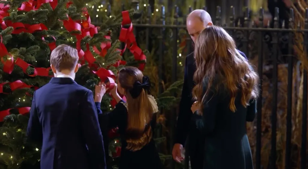 Princess Charlotte and Kate Middleton decorating a Christmas tree.