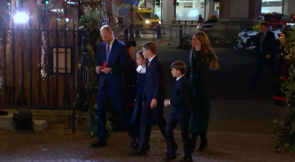 Kate Middleton and her family walking outside at night.