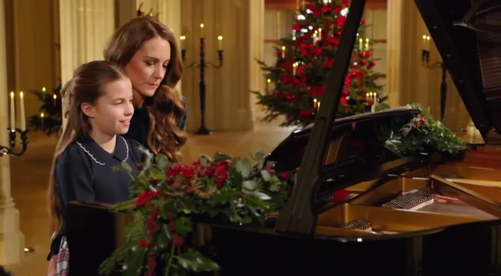 Kate Middleton and Princess Charlotte playing a piano duet during a Christmas carol service.