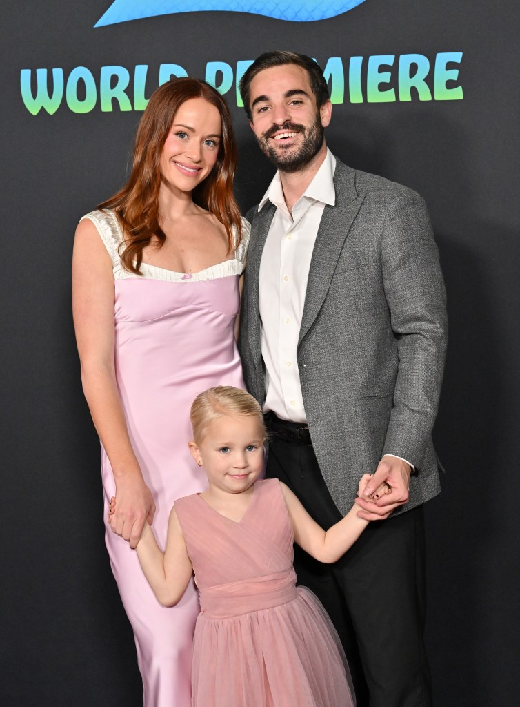Whitney Leavitt and Conner Leavitt with a young girl at the Zootopia 2 premiere.