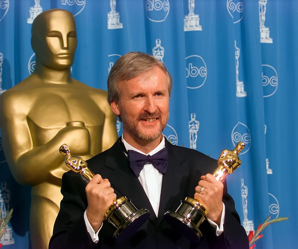 James Cameron holds his Oscar Awards backstage at Academy Awards Show, March 23, 1998.