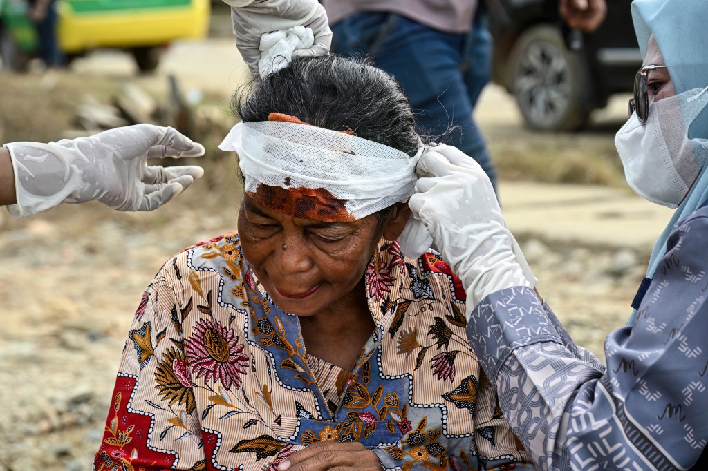 A woman receiving medical treatment for a head injury sustained in a flash flood.