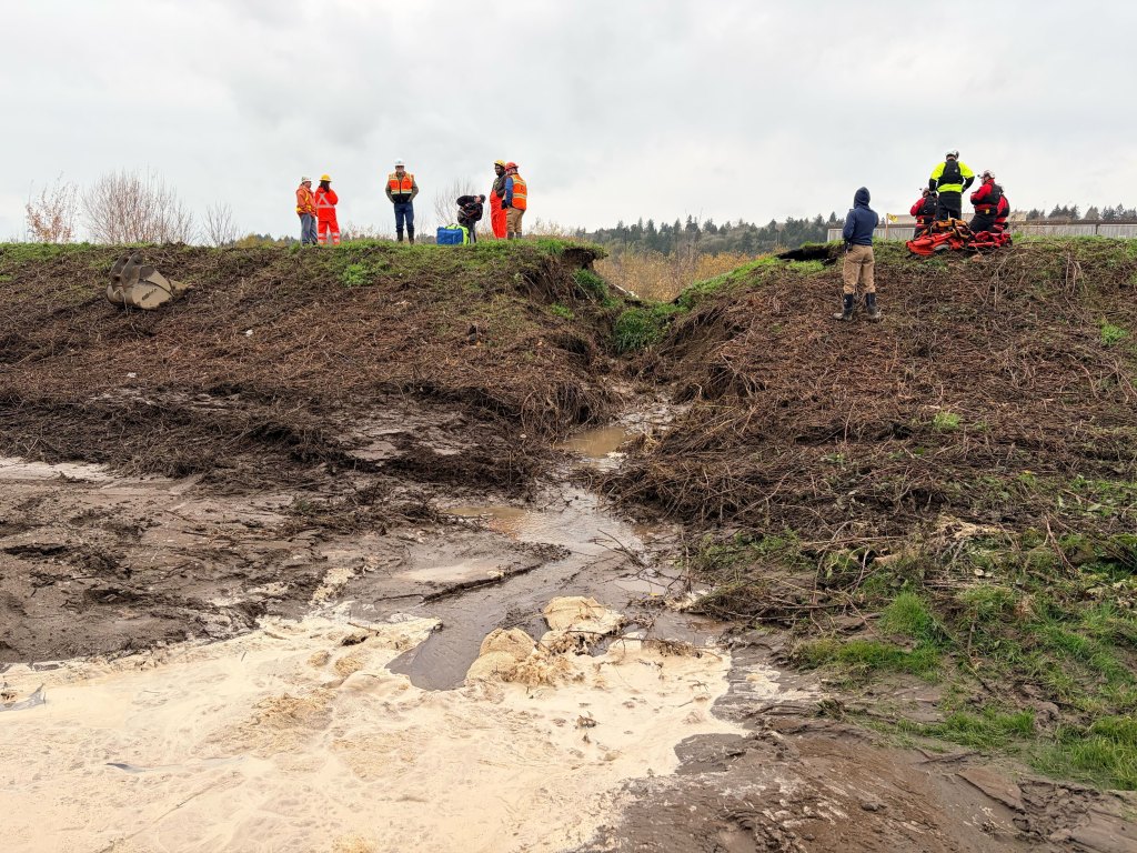 Workers at the breached Desimone Levee in Tukwila, Washington.