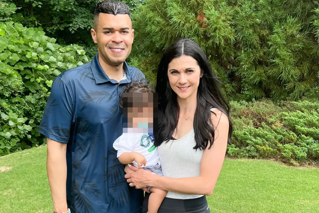 Christina Chambers, a man, and a baby stand in a garden.