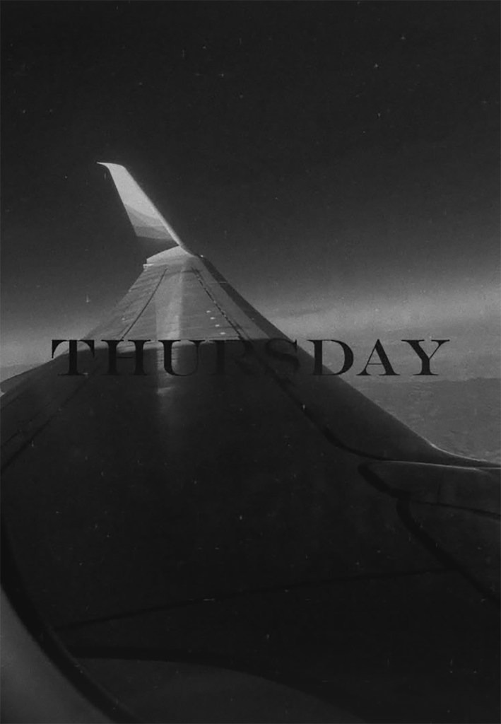 A black and white image of an airplane wing with the text