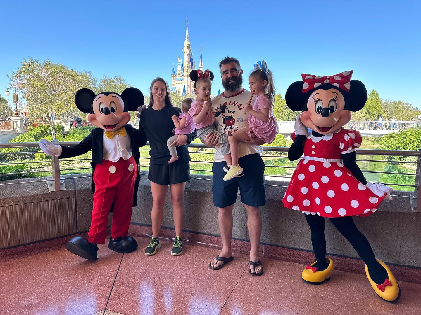 Kylie and Jason Kelce posing with their daughters and Mickey and Minnie Mouse at Disney World.