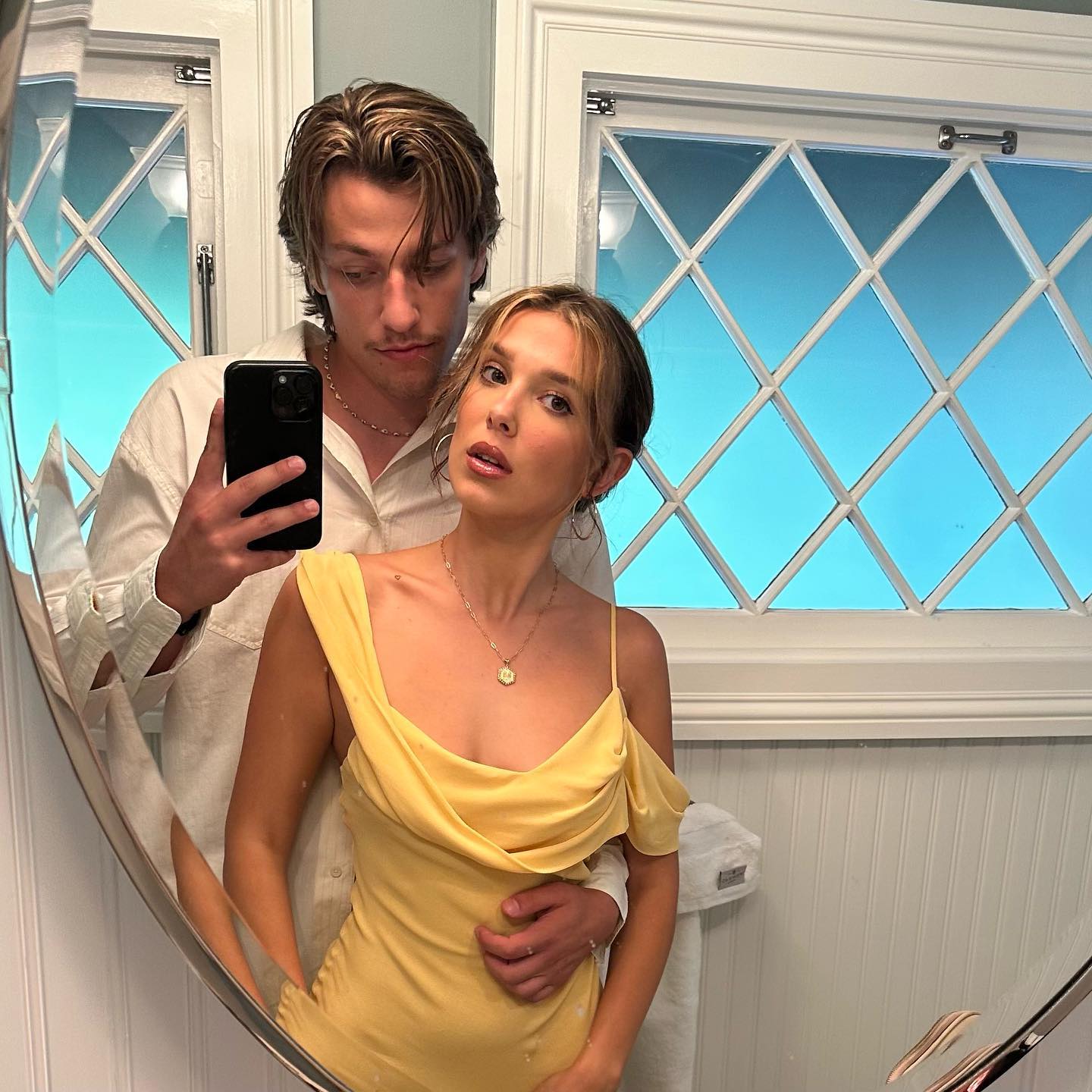 Millie Bobby Brown and Jake Bongiovi taking a mirror selfie.