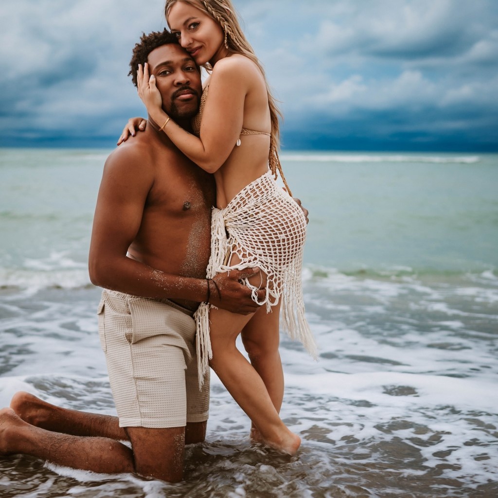 Mackenzie McKee and her fiancé Khesanio Hall standing on the beach.