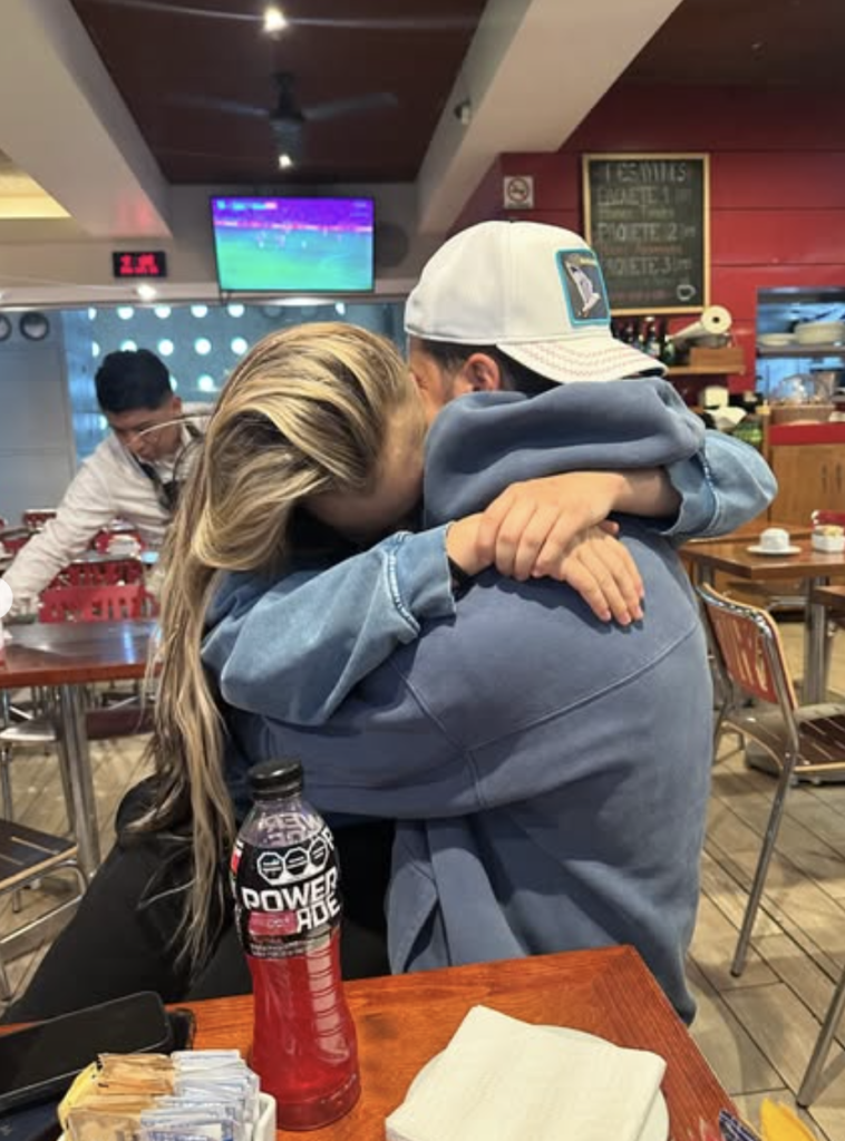 Jojo Siwa and Chris Hughes hugging.