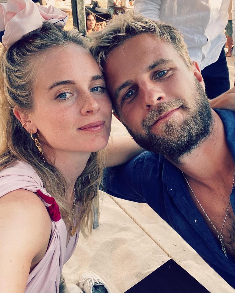 A man and a woman in a selfie, leaning in towards each other with their heads touching.