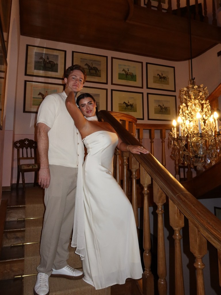 Kalani Hilliker and Nathan Goldman posing on a staircase.