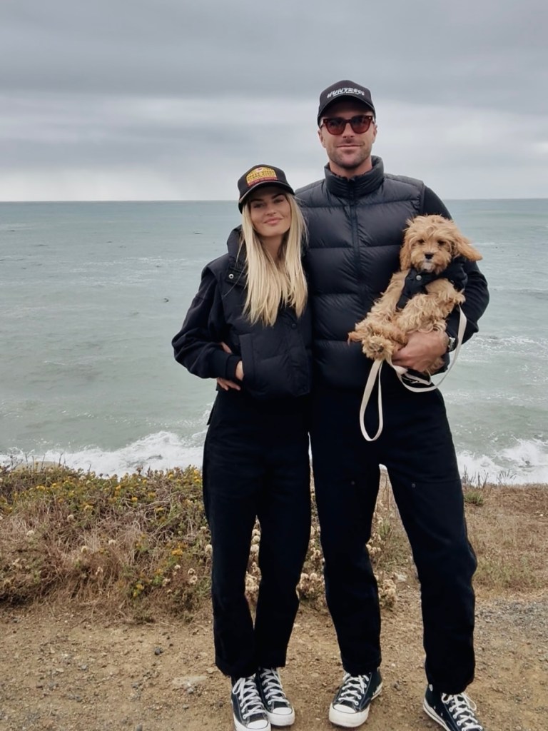 Tyler Stanaland, Hannah Morrissey, and their dog at the ocean.