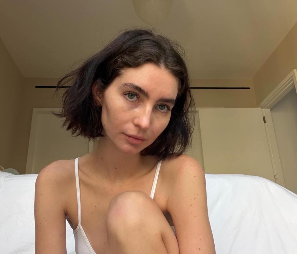 Meadow Walker wearing a white camisole.