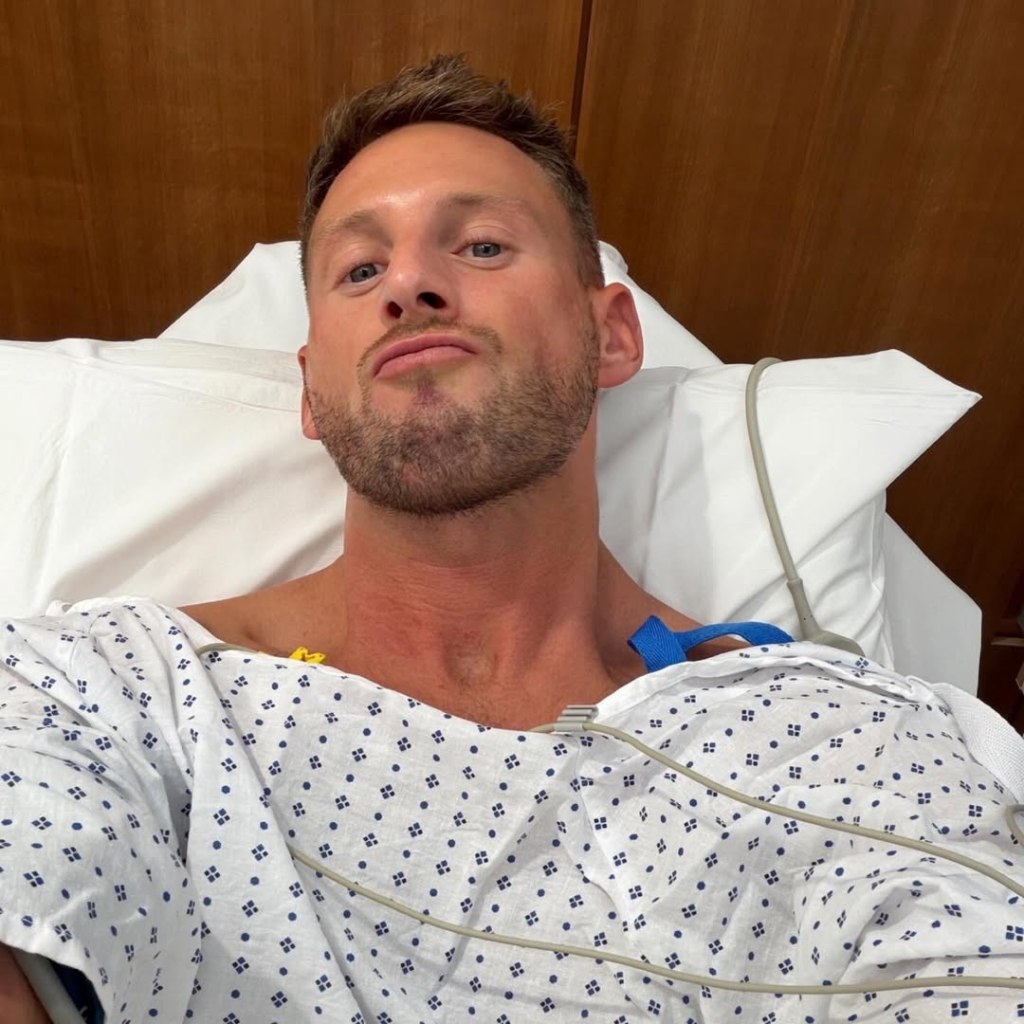 Fraser Olender in a hospital bed with medical wires attached to his chest.